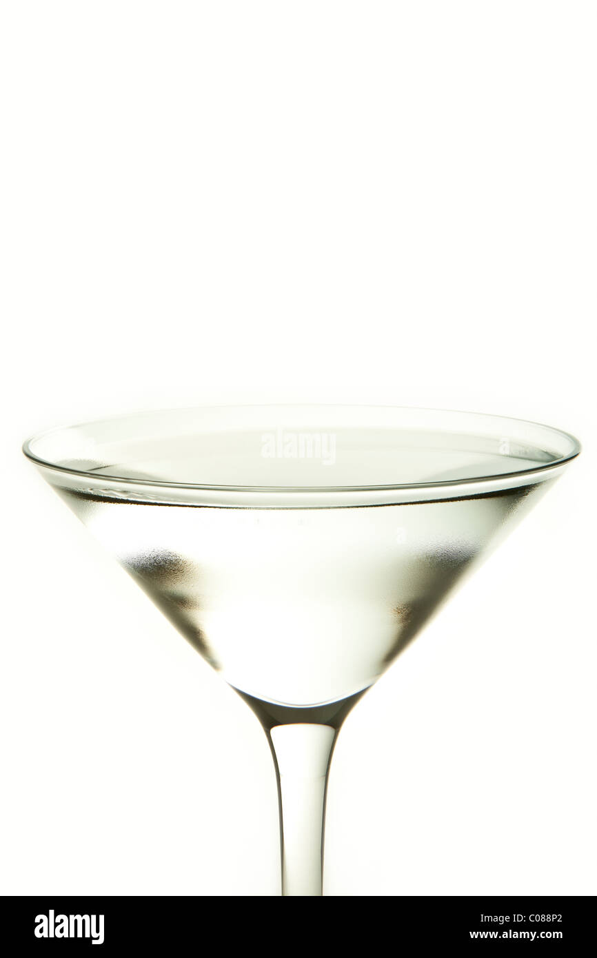 A glass of Martini Cocktail with Olive Garnish on a white background. Stock Photo