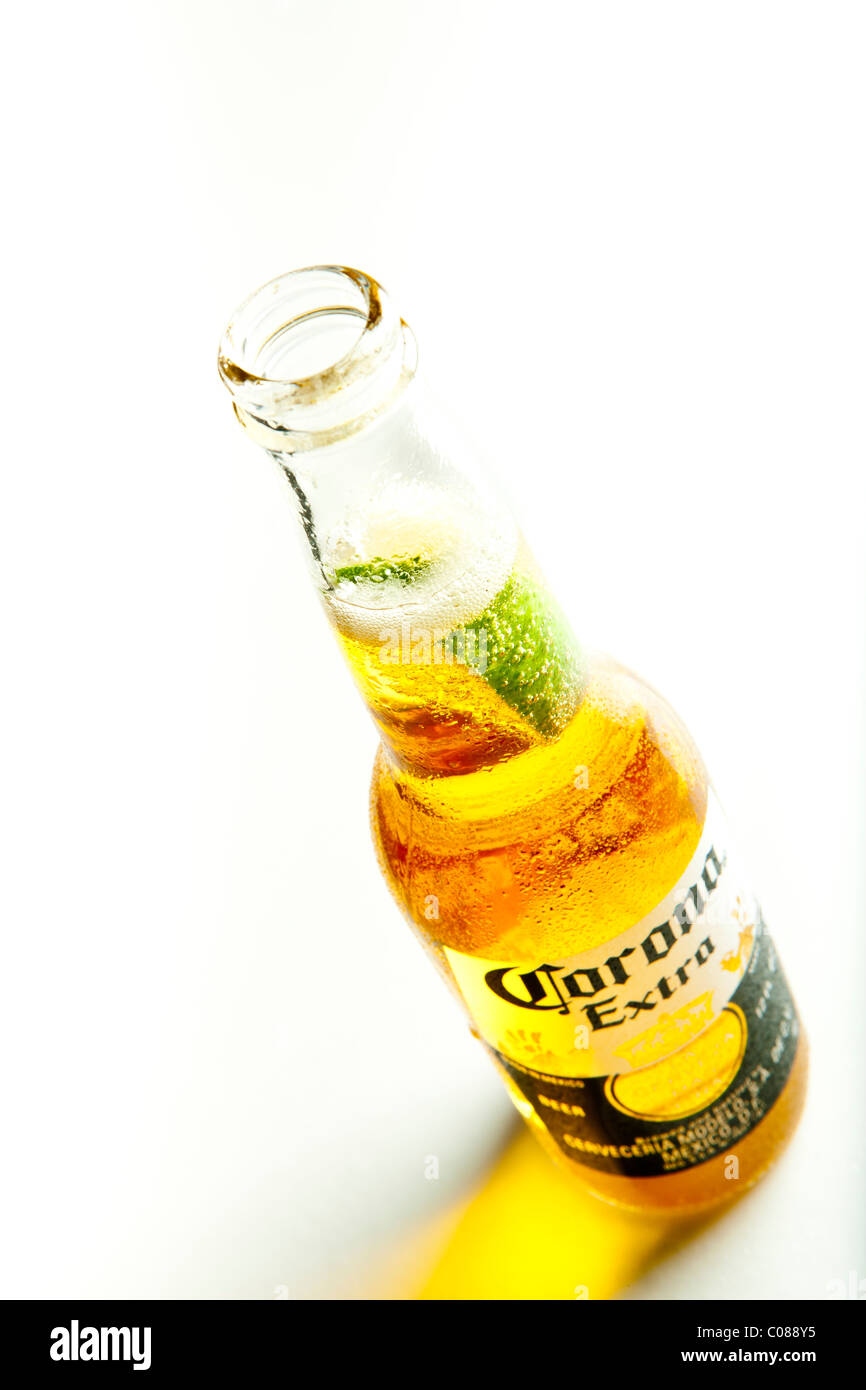 A Bottle of Corona Beer with a slice of lime on a white background. Stock Photo
