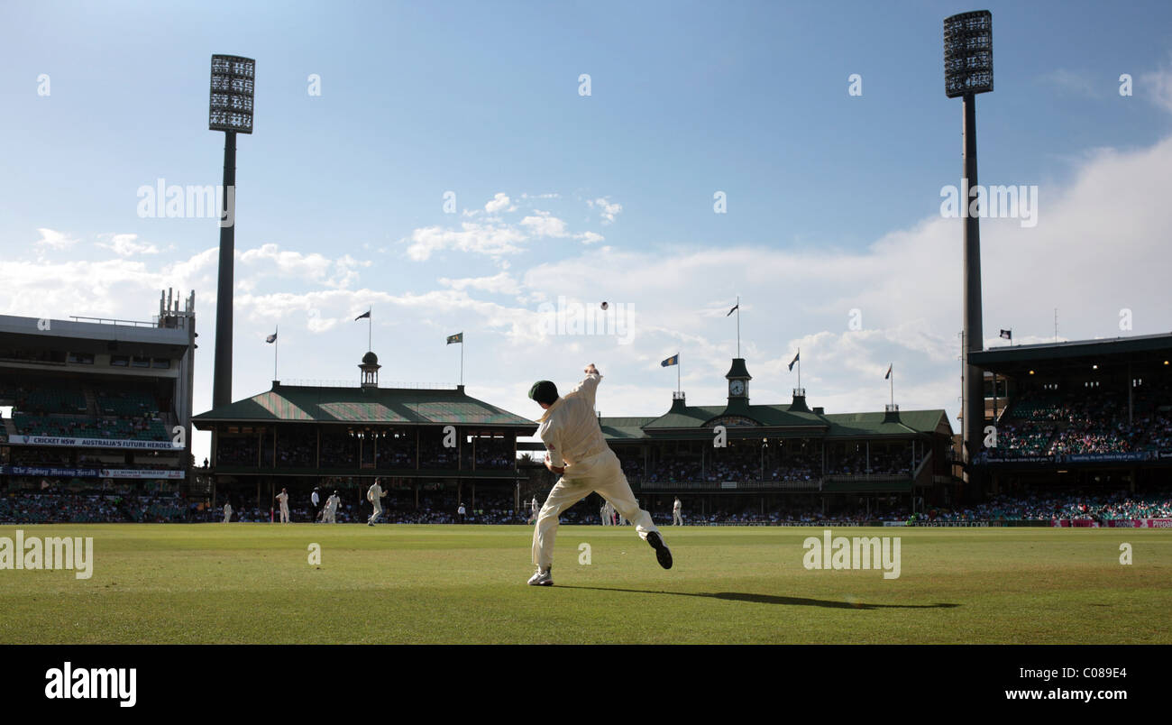 Australian fielder Michael Hussey throws the ball after fielding near the boundary at the Sydney Cricket Ground Stock Photo
