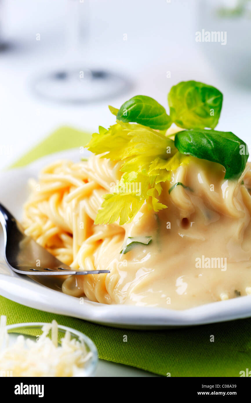 Spaghetti with creamy sauce and grated Parmesan Stock Photo
