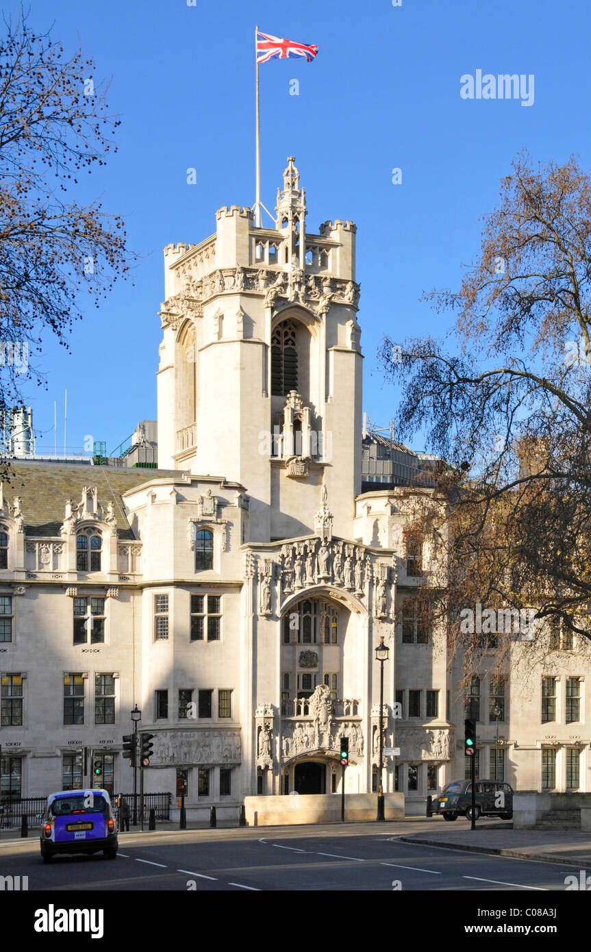Union Flag flying on clear blue sunny day above tower of old Middlesex Guildhall building now UK Supreme court in Parliament Square London England UK Stock Photo