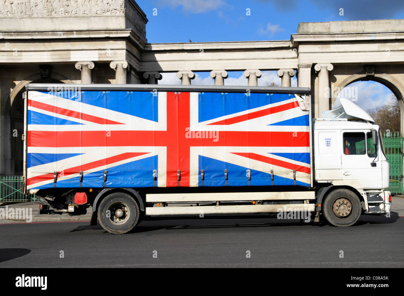 Soft sided curtain lorry truck with red white and blue Union Jack flag emblem covering load area London England UK Stock Photo