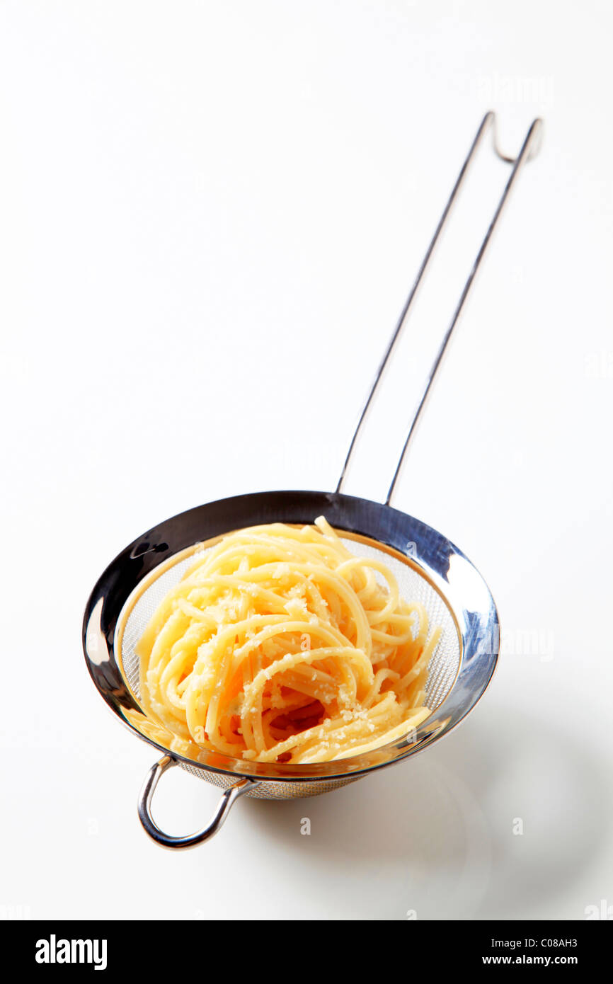Cooked spaghetti sprinkled with grated cheese Stock Photo