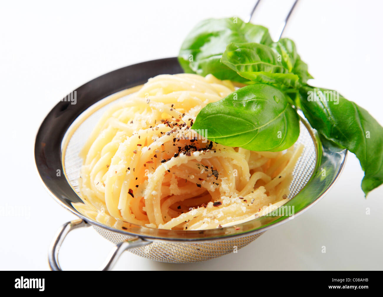 Spaghetti sprinkled with cheese and vegetable mix Stock Photo