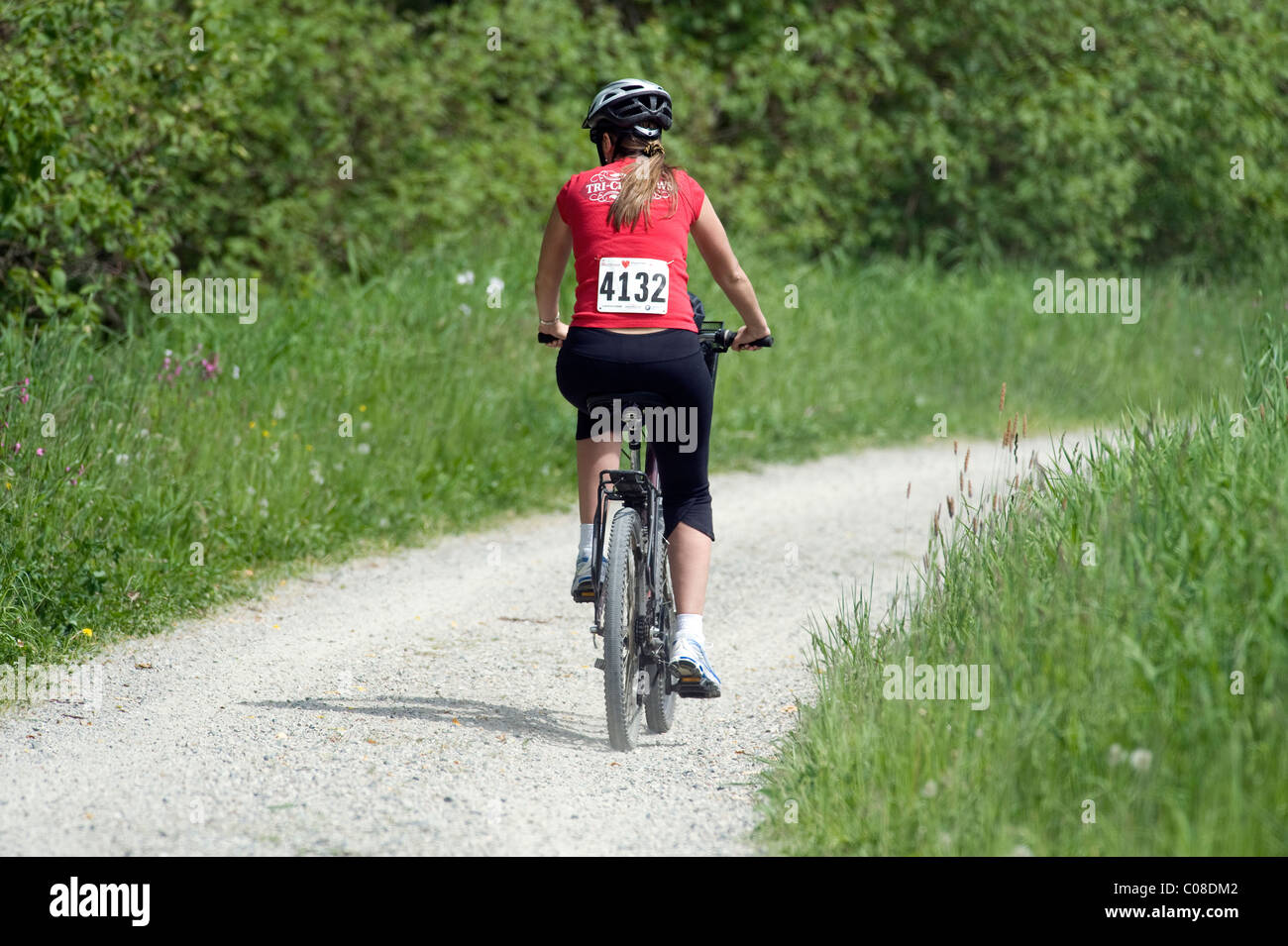 Young lady biking in park Stock Photo