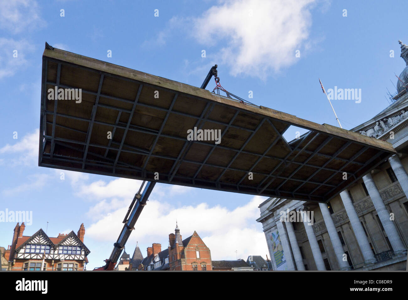 A lorry crane jib hoists part of a crazy golf course into place