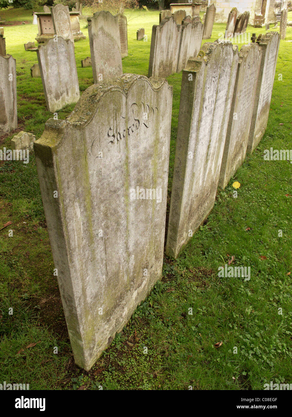 grave stones on grass in a church yard Stock Photo
