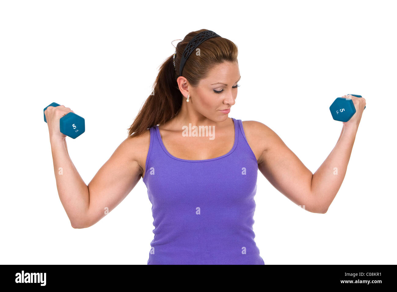 Woman uses dumbbells to do resistance weight training exercises Stock