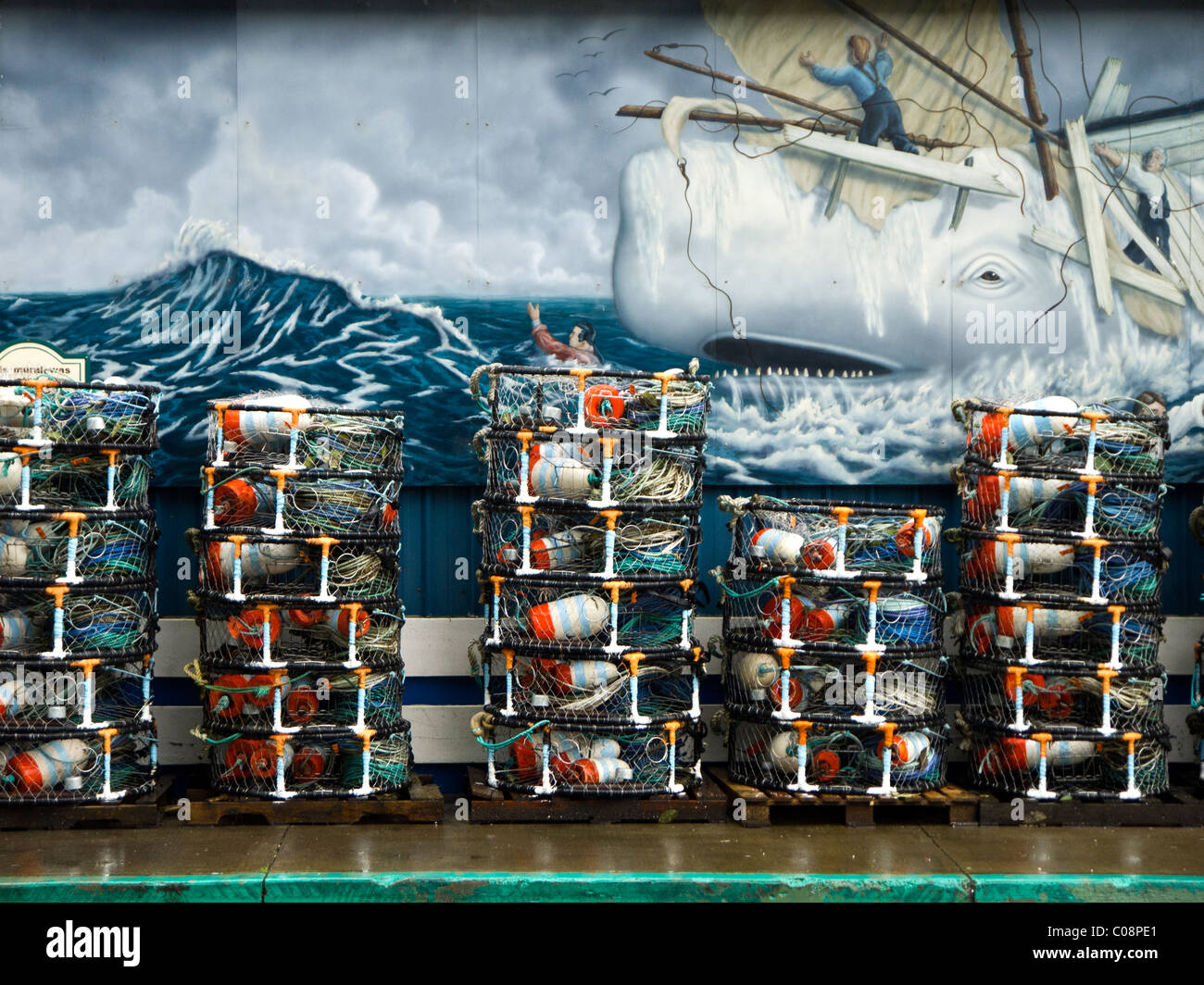 Crab pots stacked in front of a mural along Newport, Oregon's historic bayfront. Stock Photo