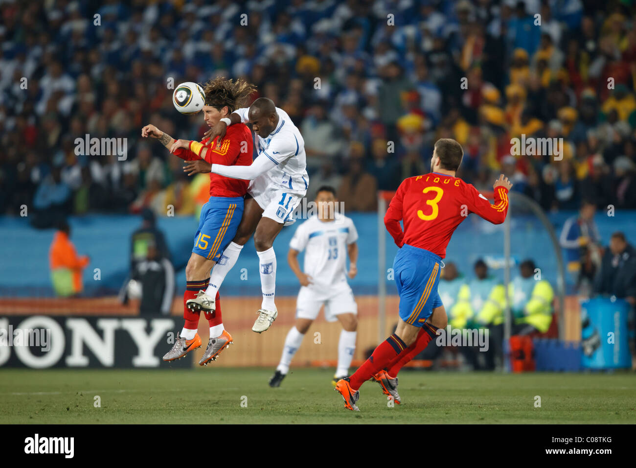 Sergio Ramos of Spain (15) jumps for a header against David Suazo of Honduras (11) during a 2010 FIFA World Cup match. Stock Photo