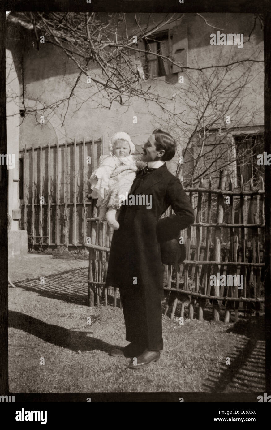 Old Photograph Of Man Holding Baby March 1907 Restored Picture Stock Photo
