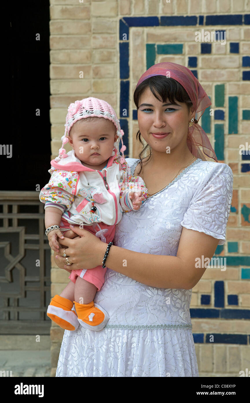 Portrait of an Uzbeki mother and child in the courtyard of the Kalon ...