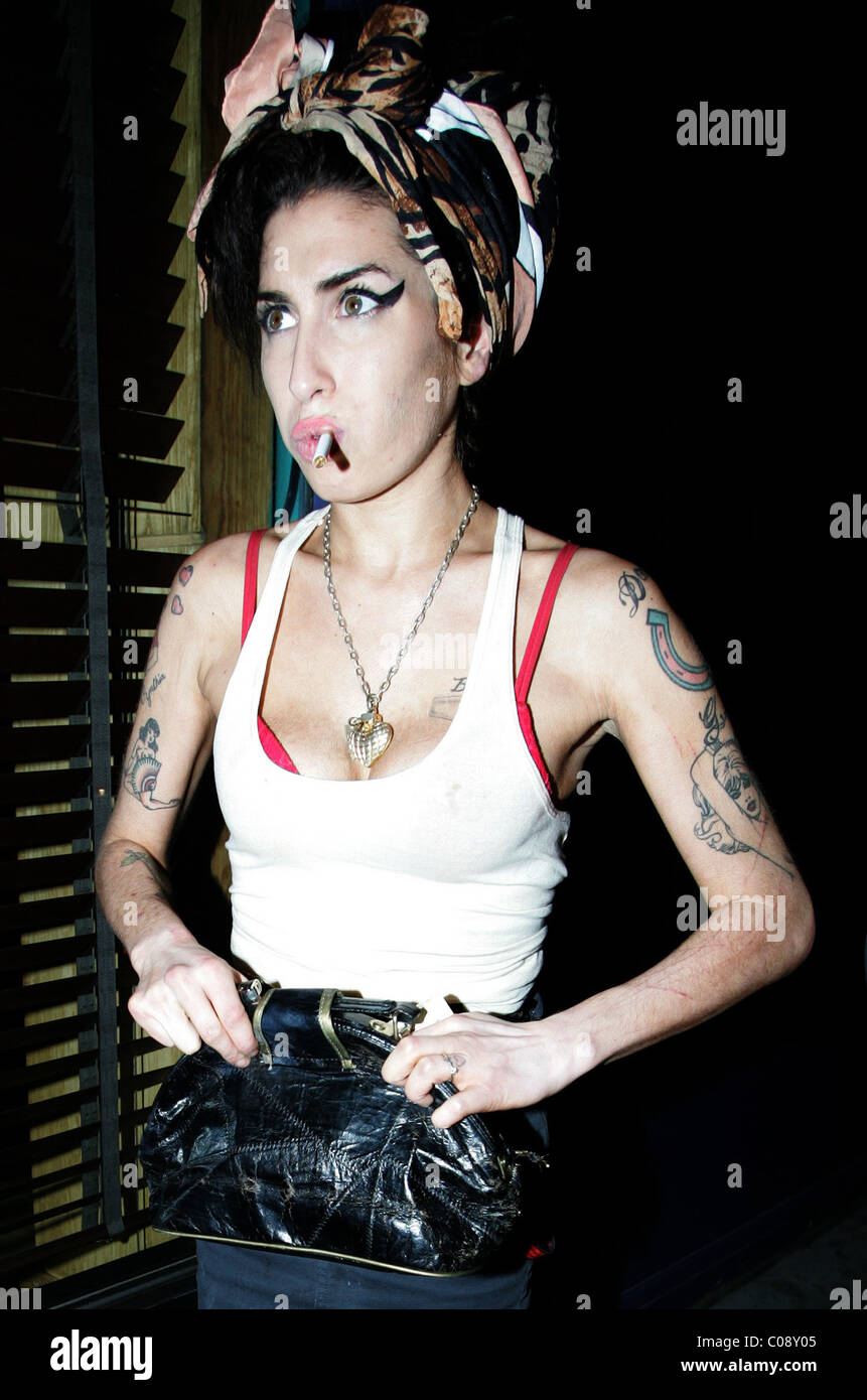 Amy Winehouse has an evening meal dining at Caribbean restaurant Mr Jerk  arriving smoking a cigarette and with fresh scratches Stock Photo