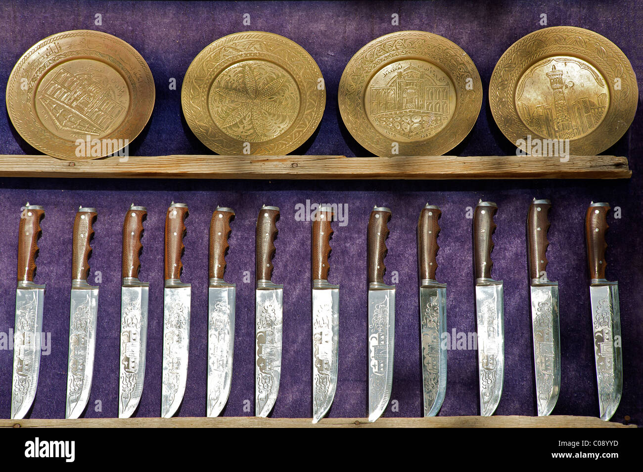 Selection of handcarved brass plates and knives, Bukhara, Uzbekistan Stock Photo