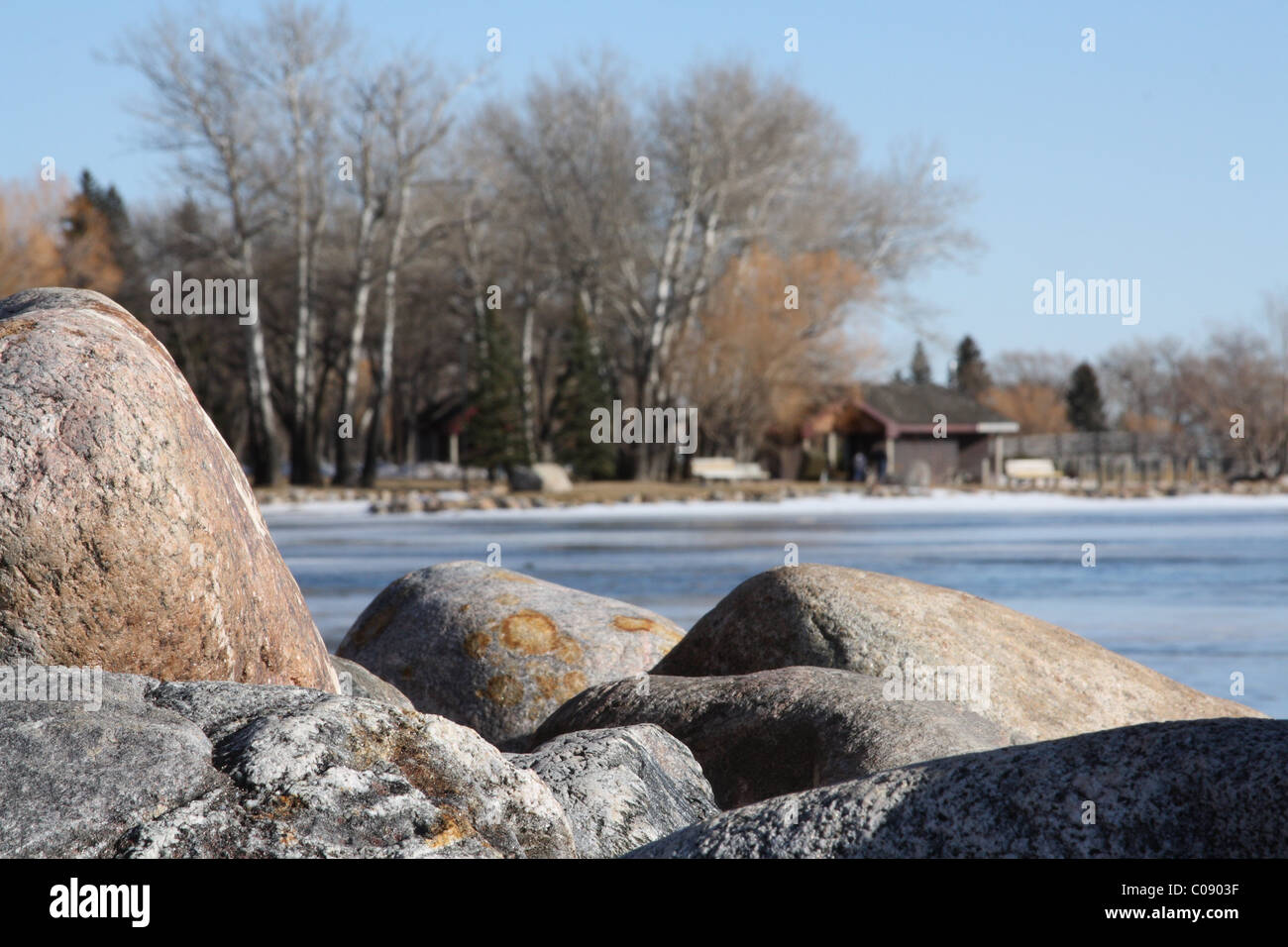 Shoreline rocks near a frozen lake Stock Photo - Alamy