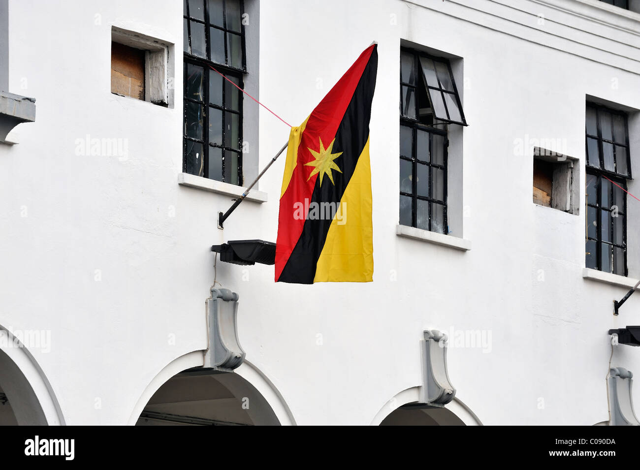 The State Flag of Sarawak, Malaysia, hanging on the old Court House in Kuching. Stock Photo