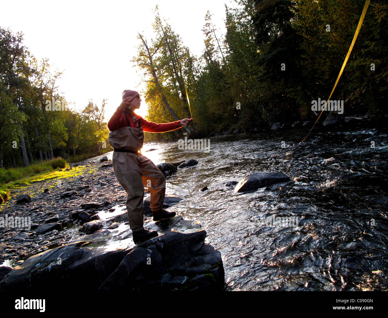 Woman fly fishing for Rainbow trout on the Russian River, Kenai