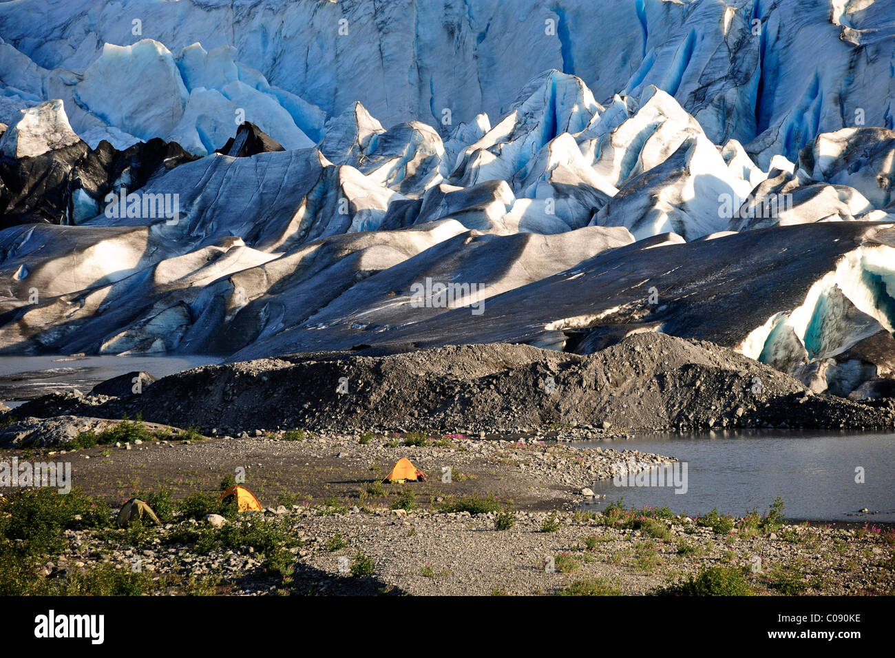 Tents pitched along the gravel beach in front of Spencer Glacier, Chugach National Forest, Southcentral Alaska, Summer Stock Photo
