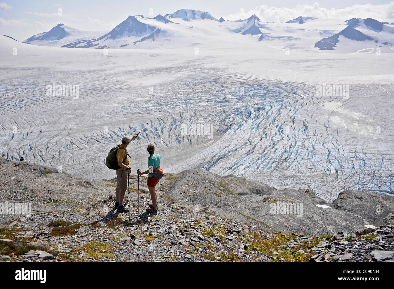 Man and woman enjoy view overlooking Harding Icefield, Kenai Fjords National Park, Kenai Peninsula, Southcentral Alaska, Summer Stock Photo