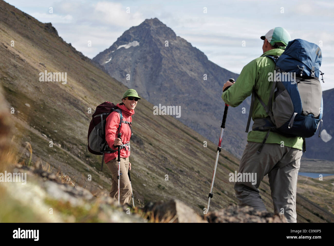 Two backpackers hiking to Ptarmigan Pass, Chugach State Park, Southcentral Alaska, Summer Stock Photo