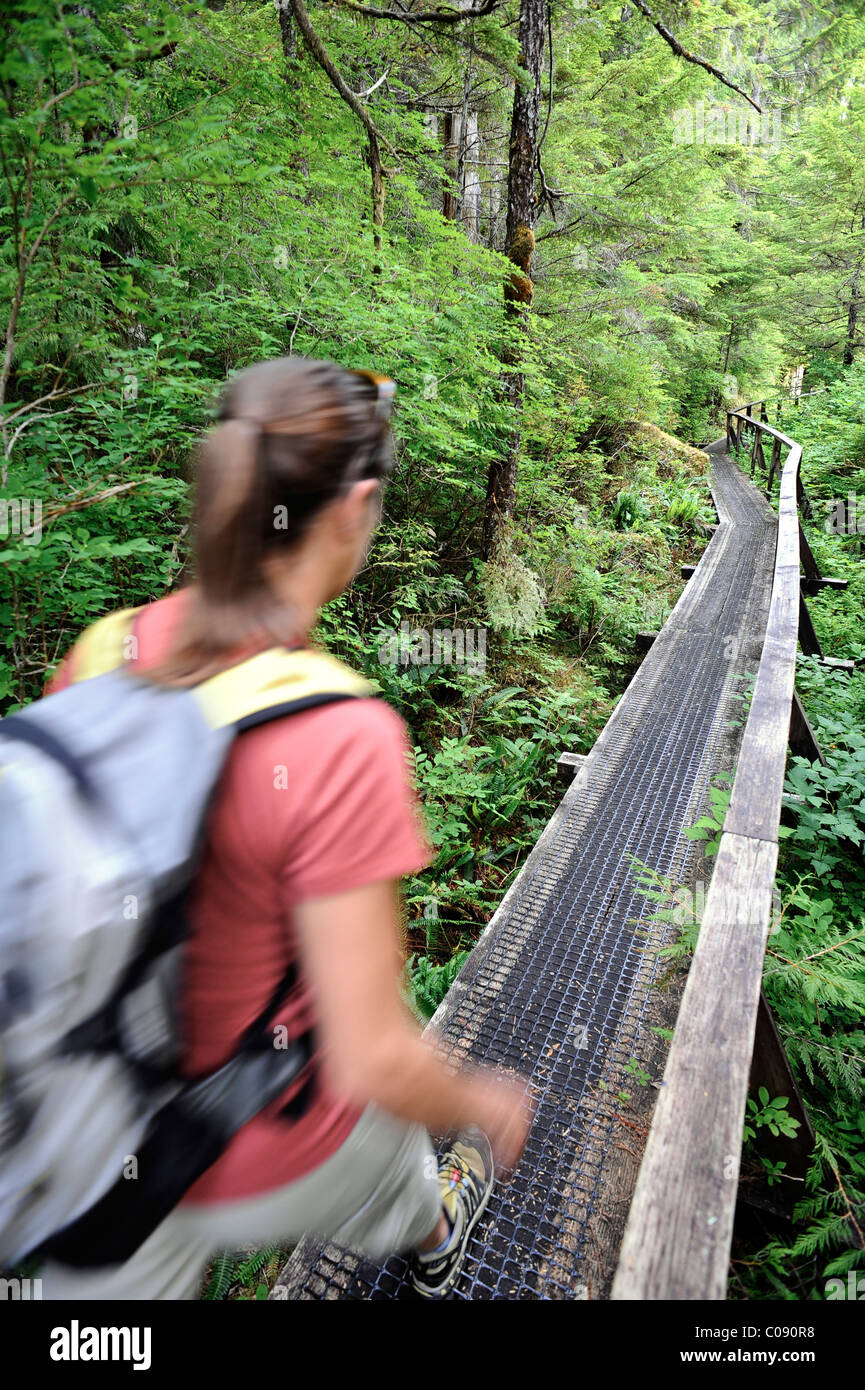 Woman hiking on the Perseverance Lake trail in Tongass National Forest near Ketchikan, Southeast Alaska, Summer Stock Photo