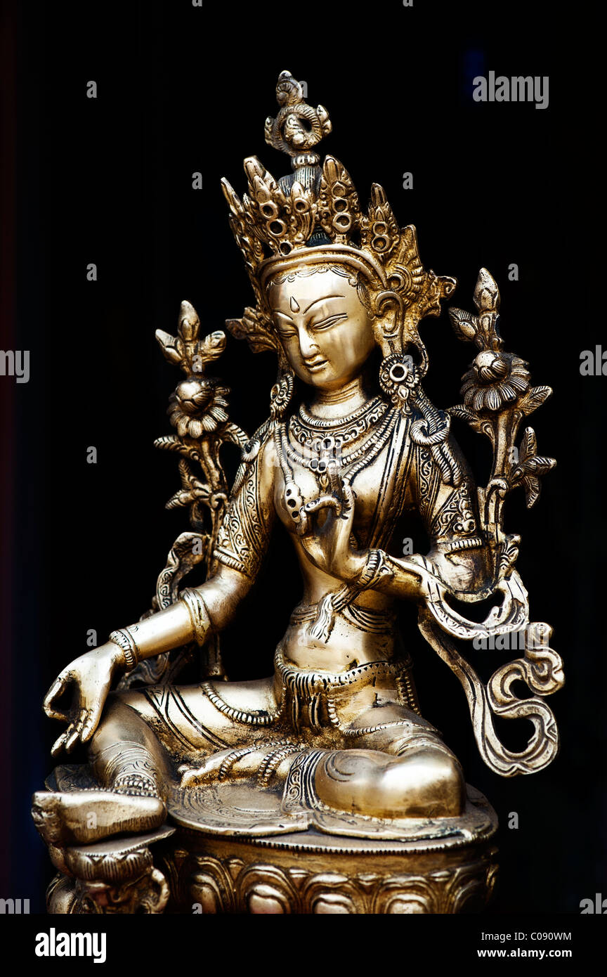 Tara Statue. Buddhist deity statue against black background Stock Photo ...