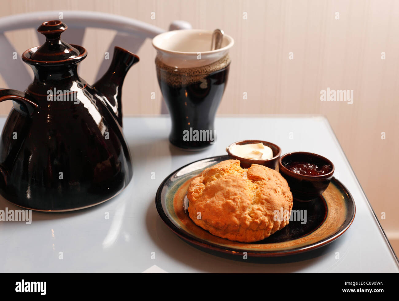 Cream tea, scone with jam and tea pot, cafe in Louis Mulcahy Pottery