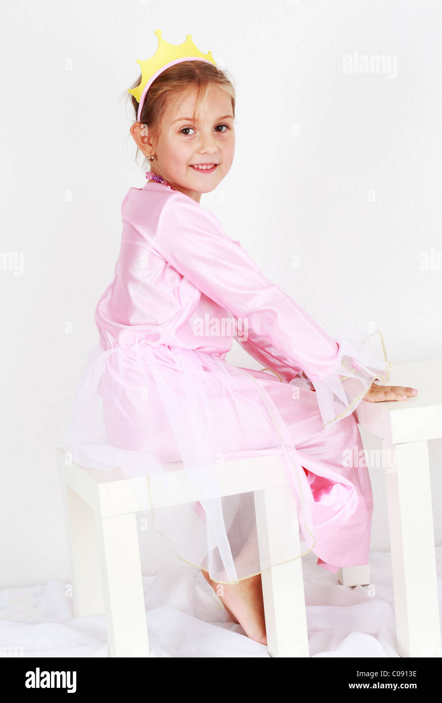 Adorable girl dressed as princess playing Stock Photo - Alamy