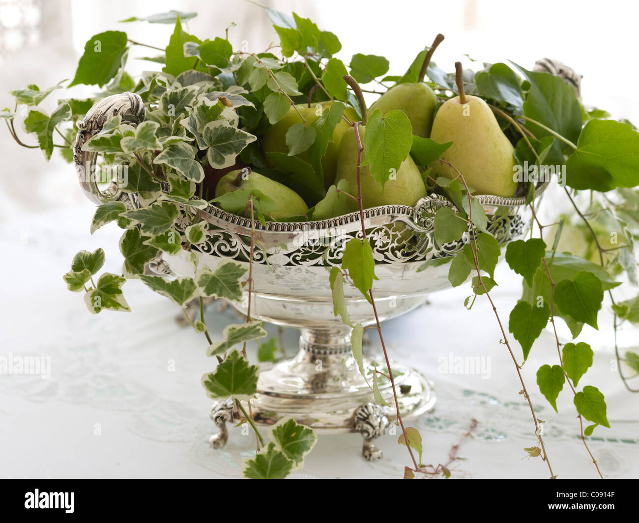 Antique silver fruit bowl with pears and stylish decoration in a noble  ambiance Stock Photo - Alamy