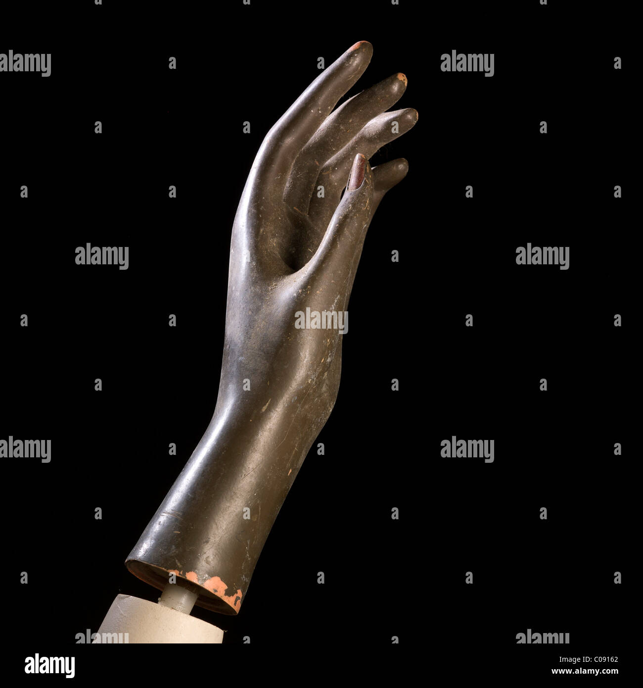 Articulated hand displayed against a dark background showcasing craftsmanship and design elements Stock Photo