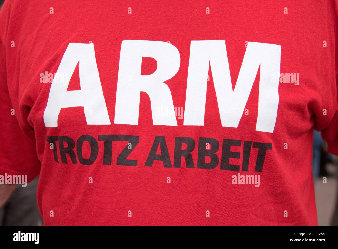 'Arm trotz Arbeit', poor despite being employed, printed on a T-shirt Stock Photo