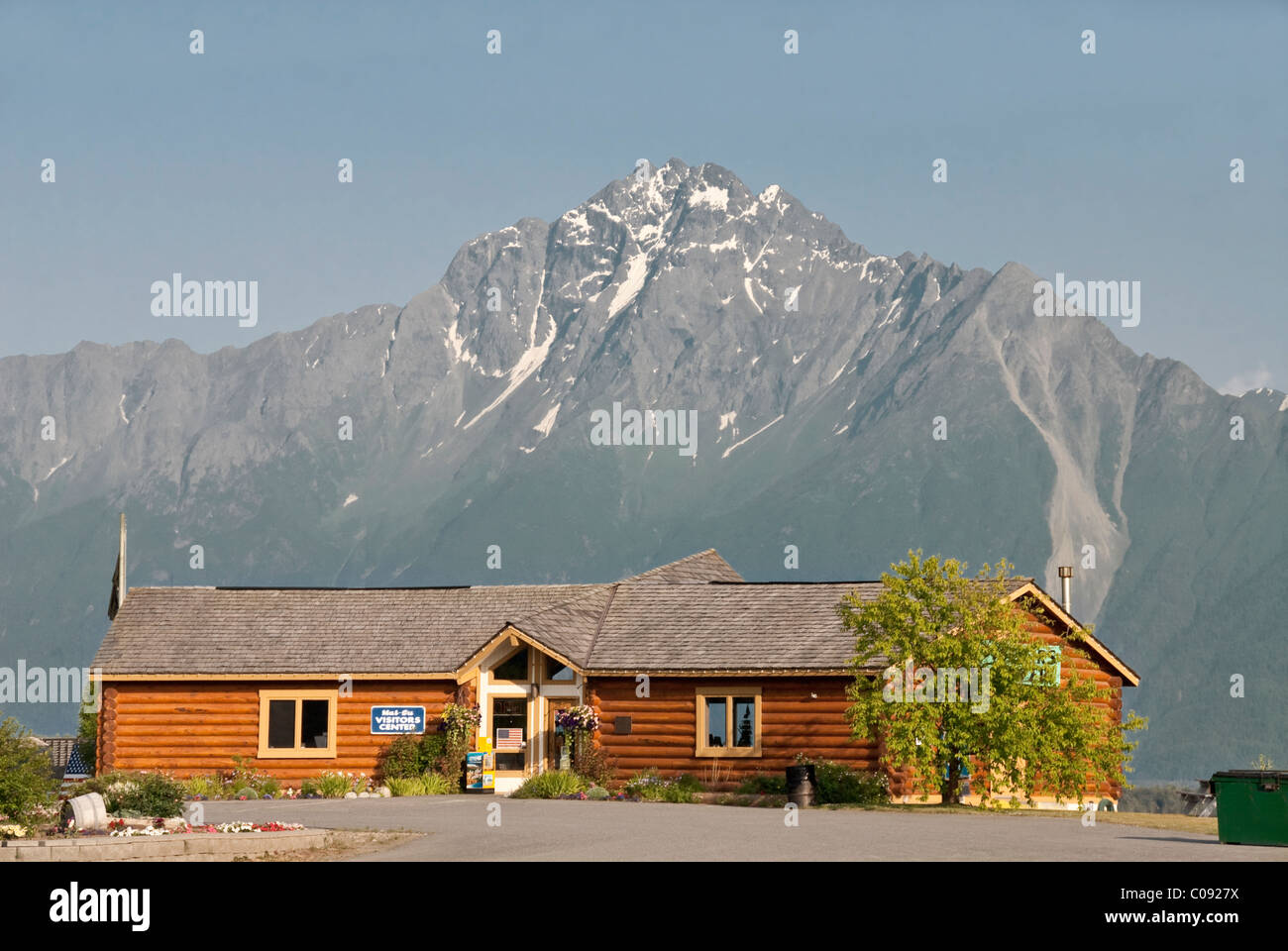Evening view of the Mat-Su Visitors Bureau cabin with Pioneer Peak in the background, Mat-Su Valley. Digitally Altered. Stock Photo