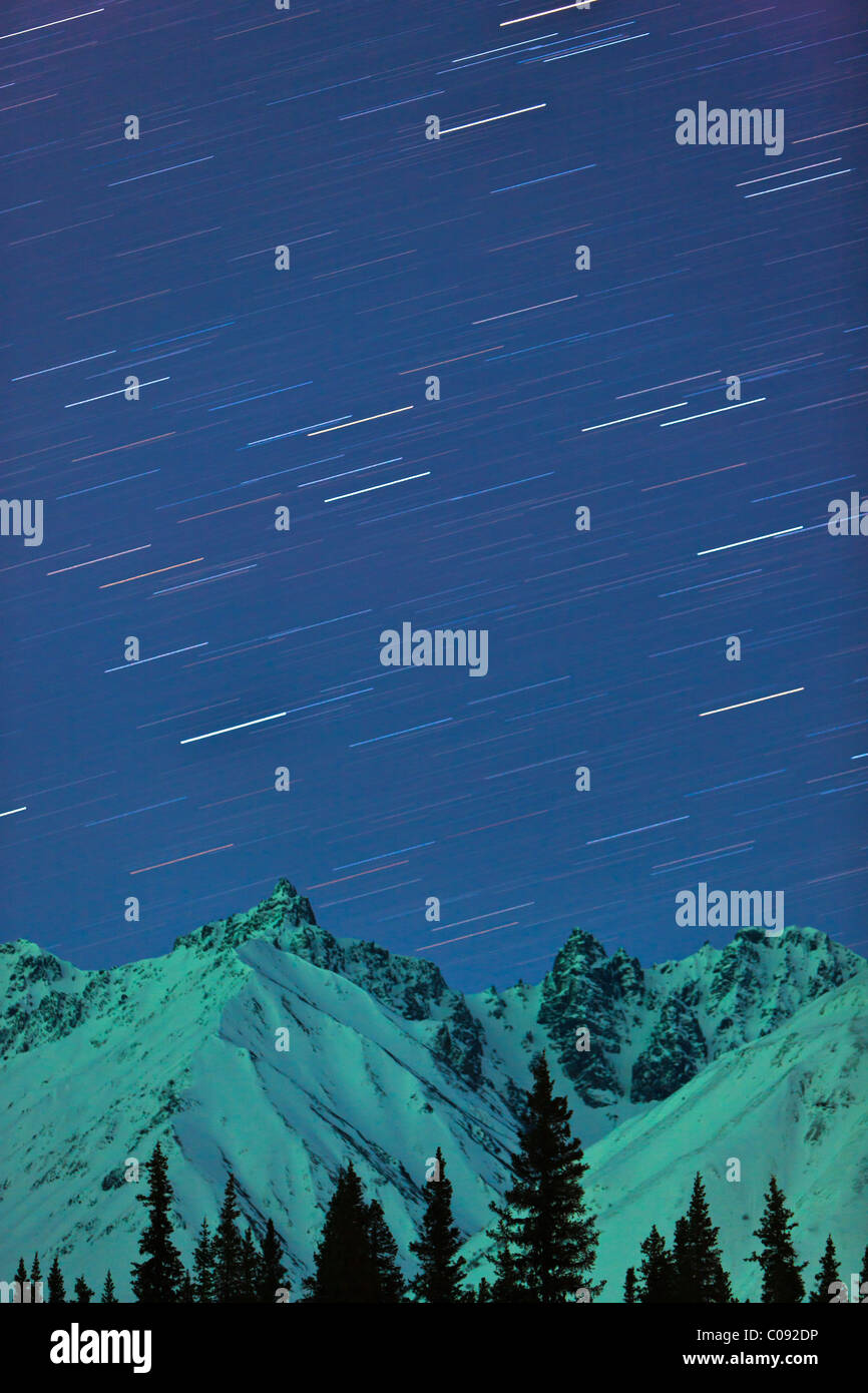 Northern Lights and star trails above the foothills of the Alaska Range