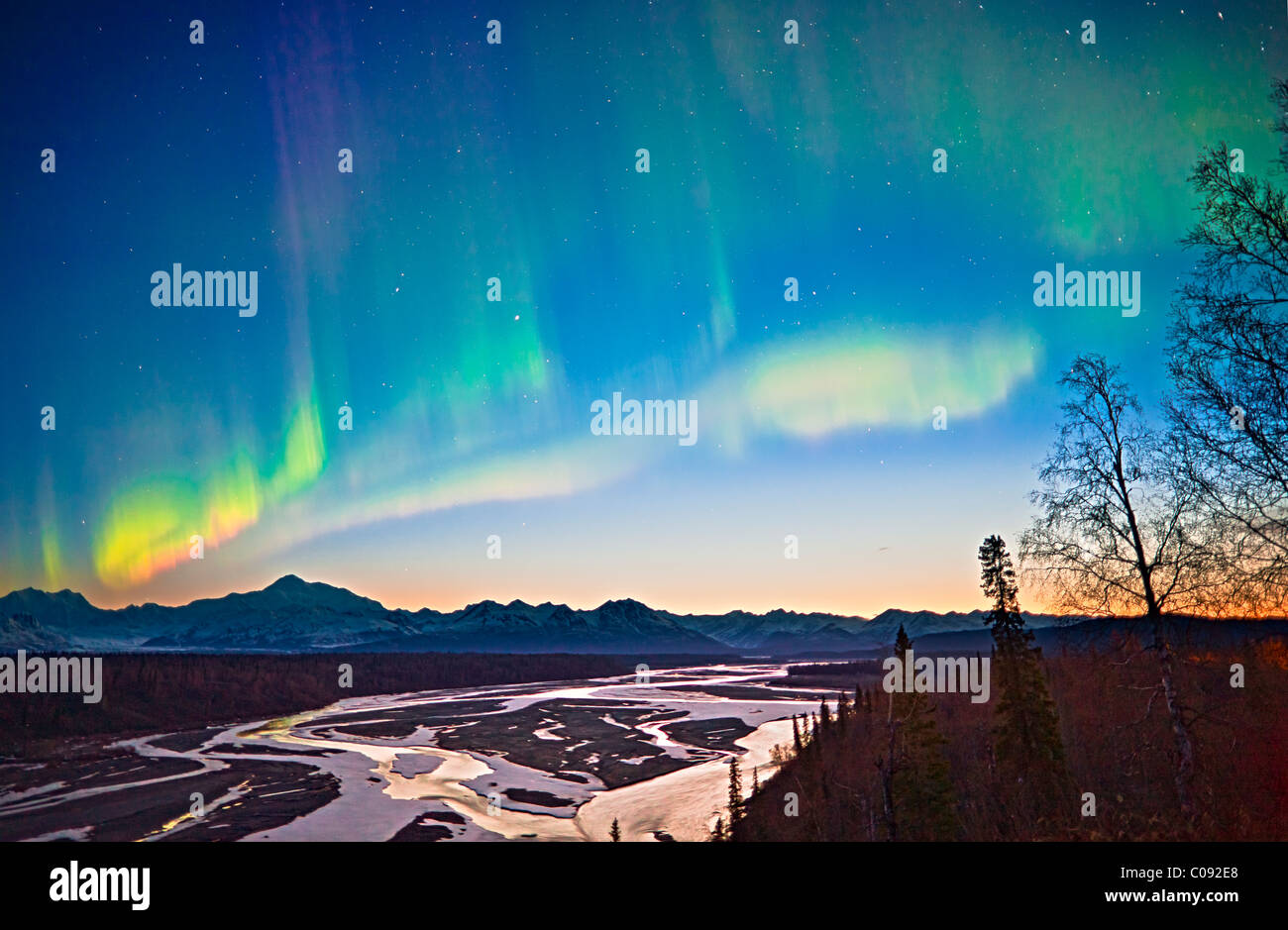 View of Northern Lights in the sky above southside Mount McKinley and the Alaska Range at twilight, Denali State Park, Alaska Stock Photo