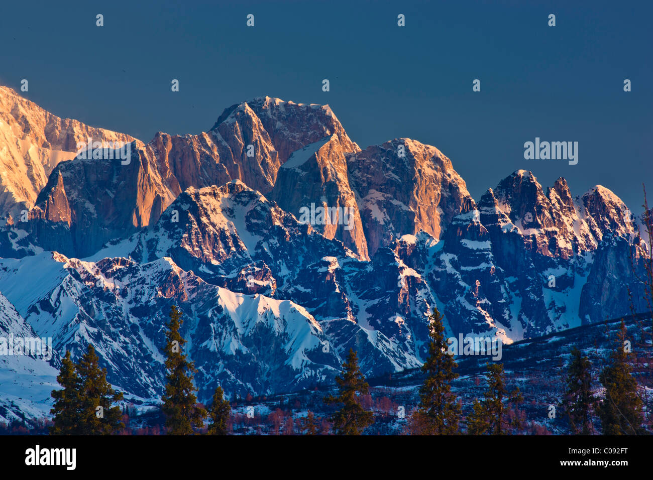 Sunrise alpenglow on the Mooses Tooth in in the Alaska Range, Denali State Park,  Southcentral Alaska, Spring Stock Photo