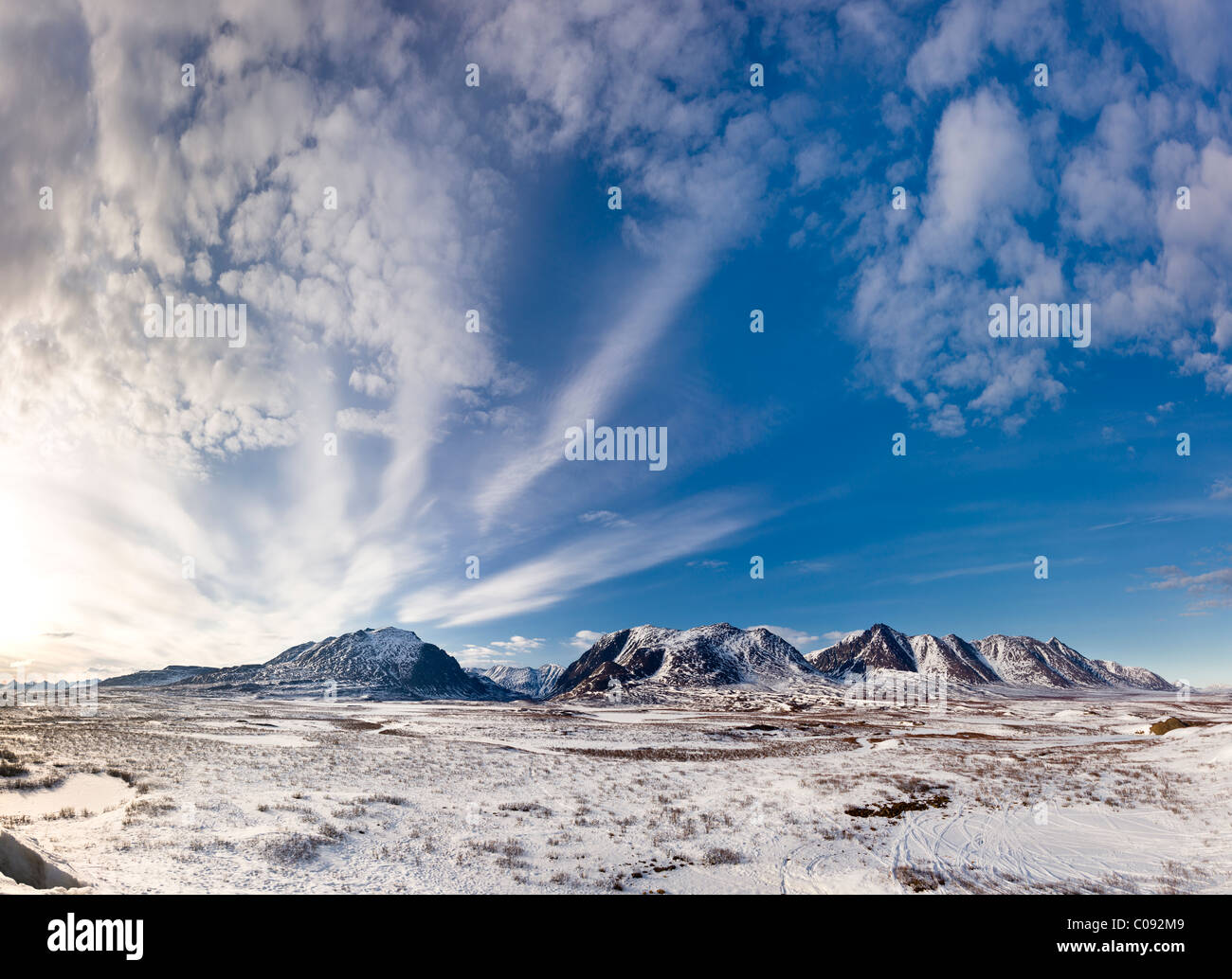 View of clouds from an approaching storm system starting to converge over MacLaren Summit along the Denali Highway, Alaska Stock Photo