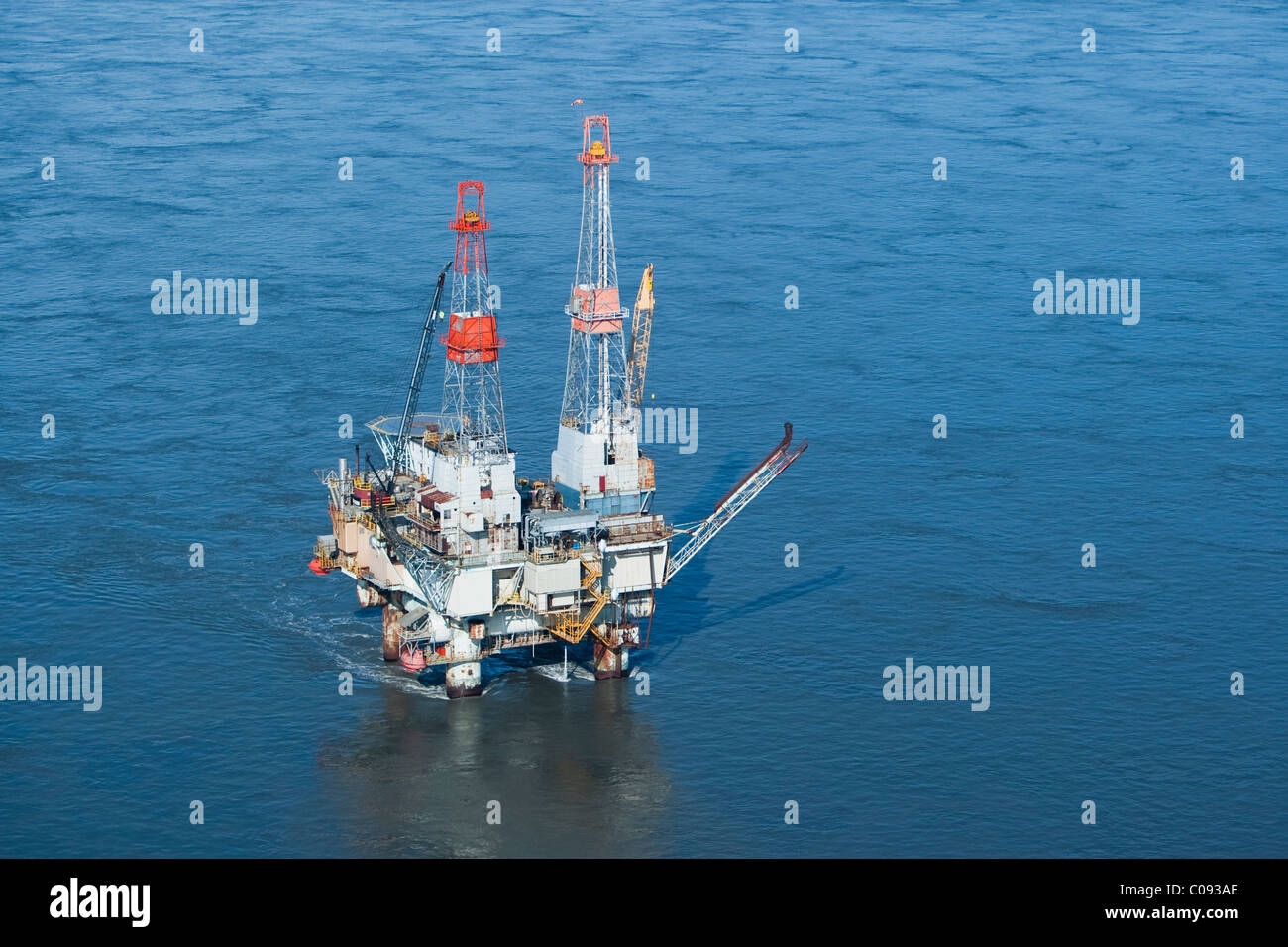 Aerial view of an oil drilling rig in the tidal currents of Cook Inlet, Southcentral Alaska, Summer Stock Photo