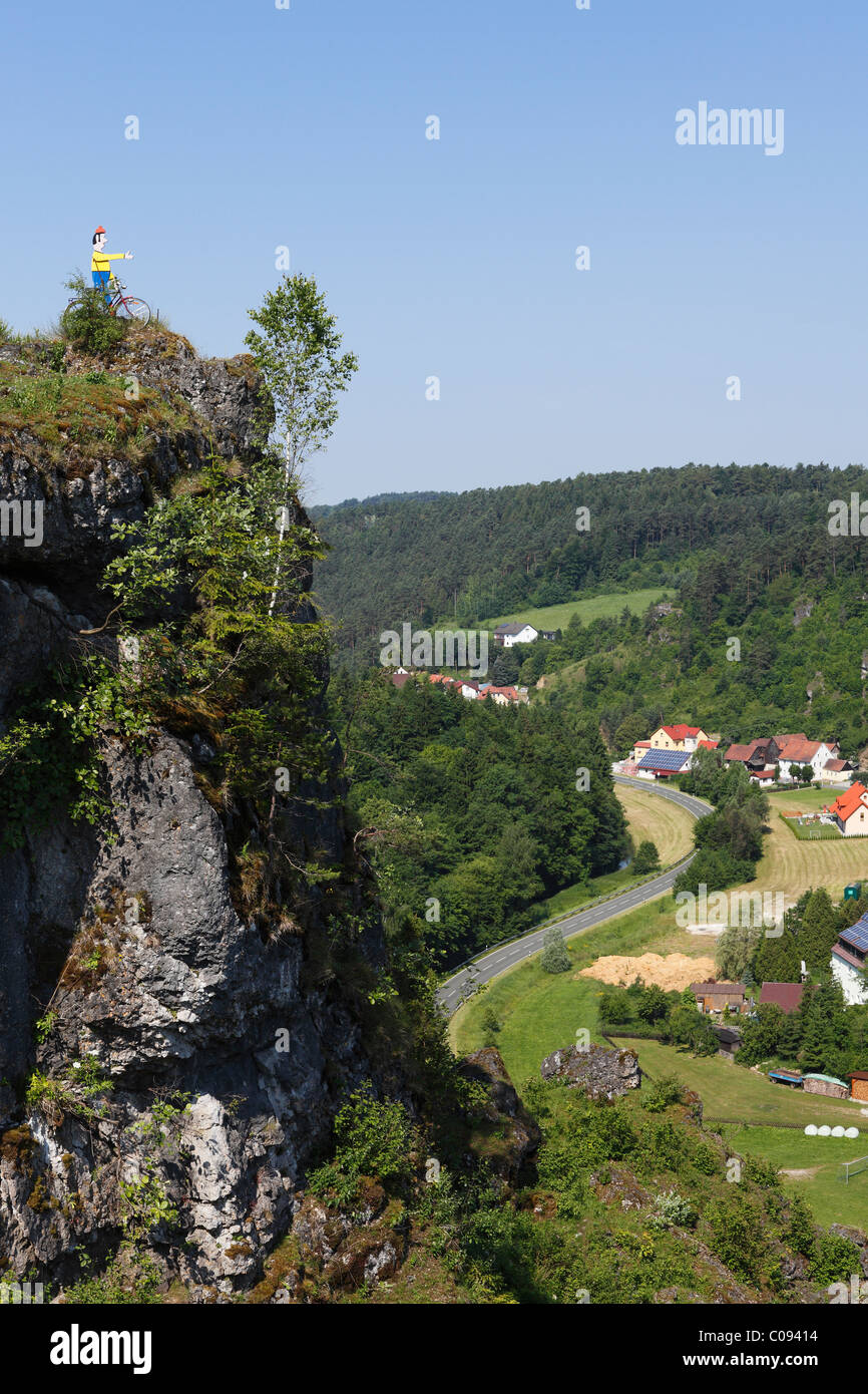 Cliff with a cyclist sculpture above Oberailsfeld, Ailsbachtal Valley, Franconian Switzerland, Franconian Alb, Upper Franconia Stock Photo