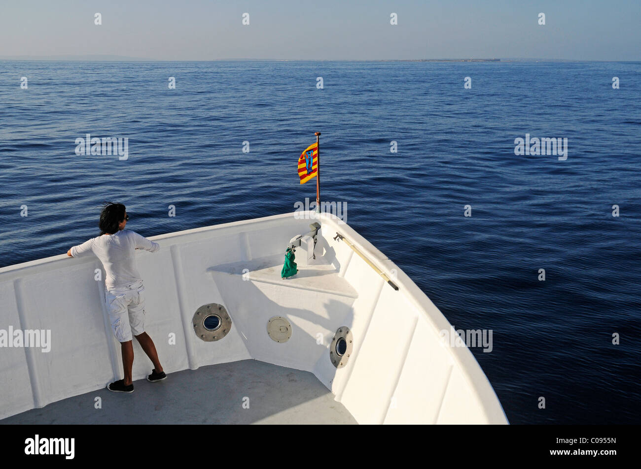 Single passenger, woman, Mediterranean, horizon, ferry service between Ibiza and Formentera, Pityuses, Balearic Islands, Spain Stock Photo