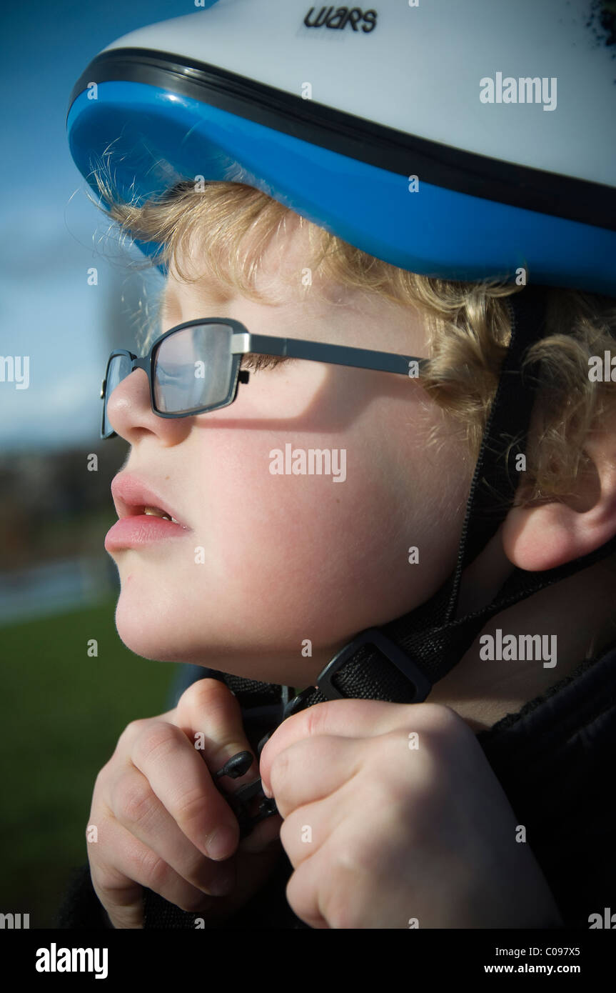 Young boy wearing bike helmet and glasses Stock Photo Alamy