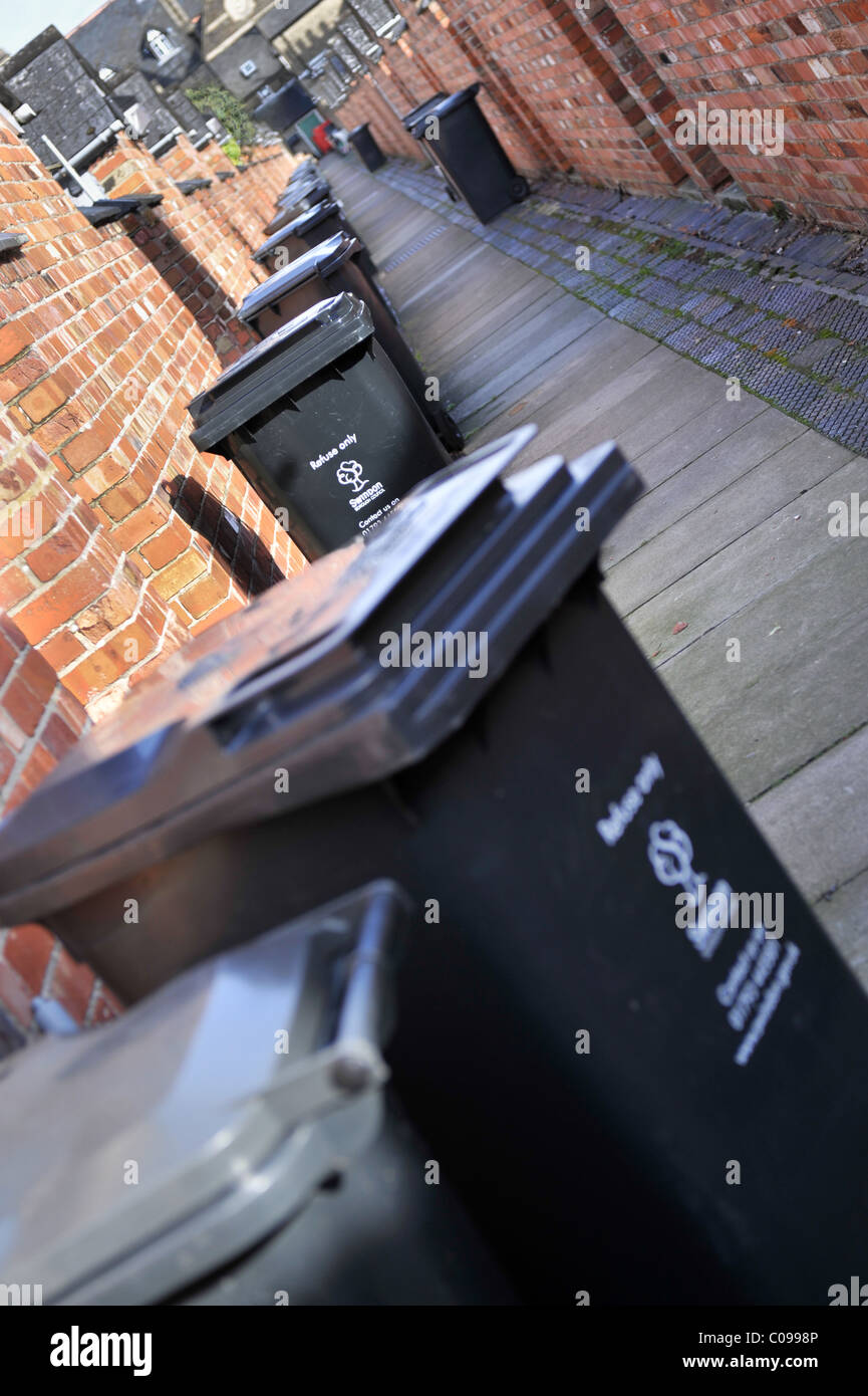 Wheelie bins in a traditional British back alley Stock Photo