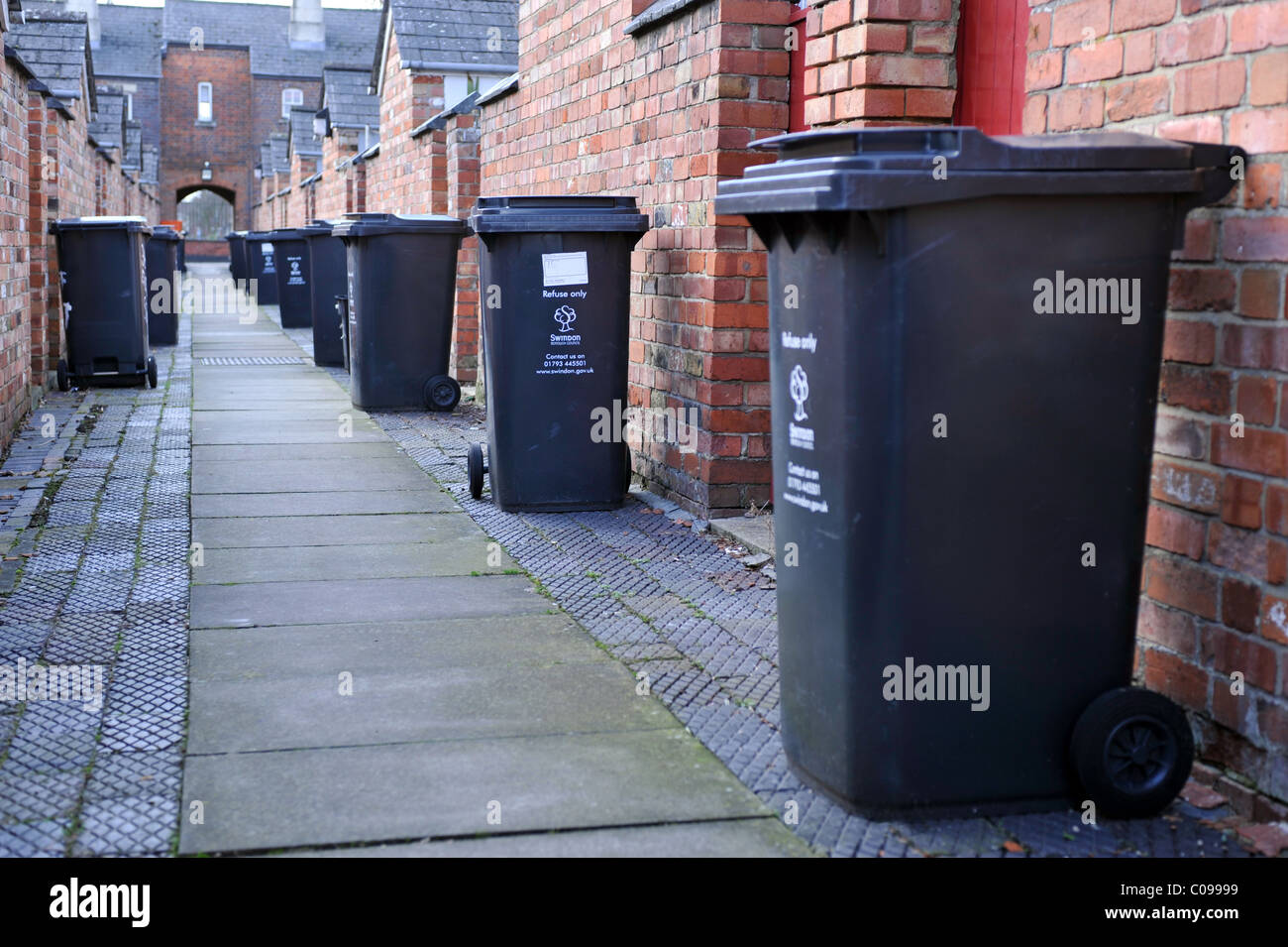 Wheelie bins in a traditional British back alley Stock Photo