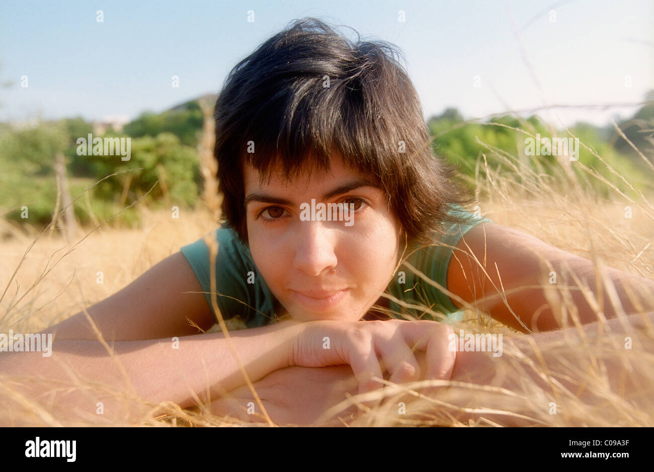 Latin girl lying on the grass Stock Photo
