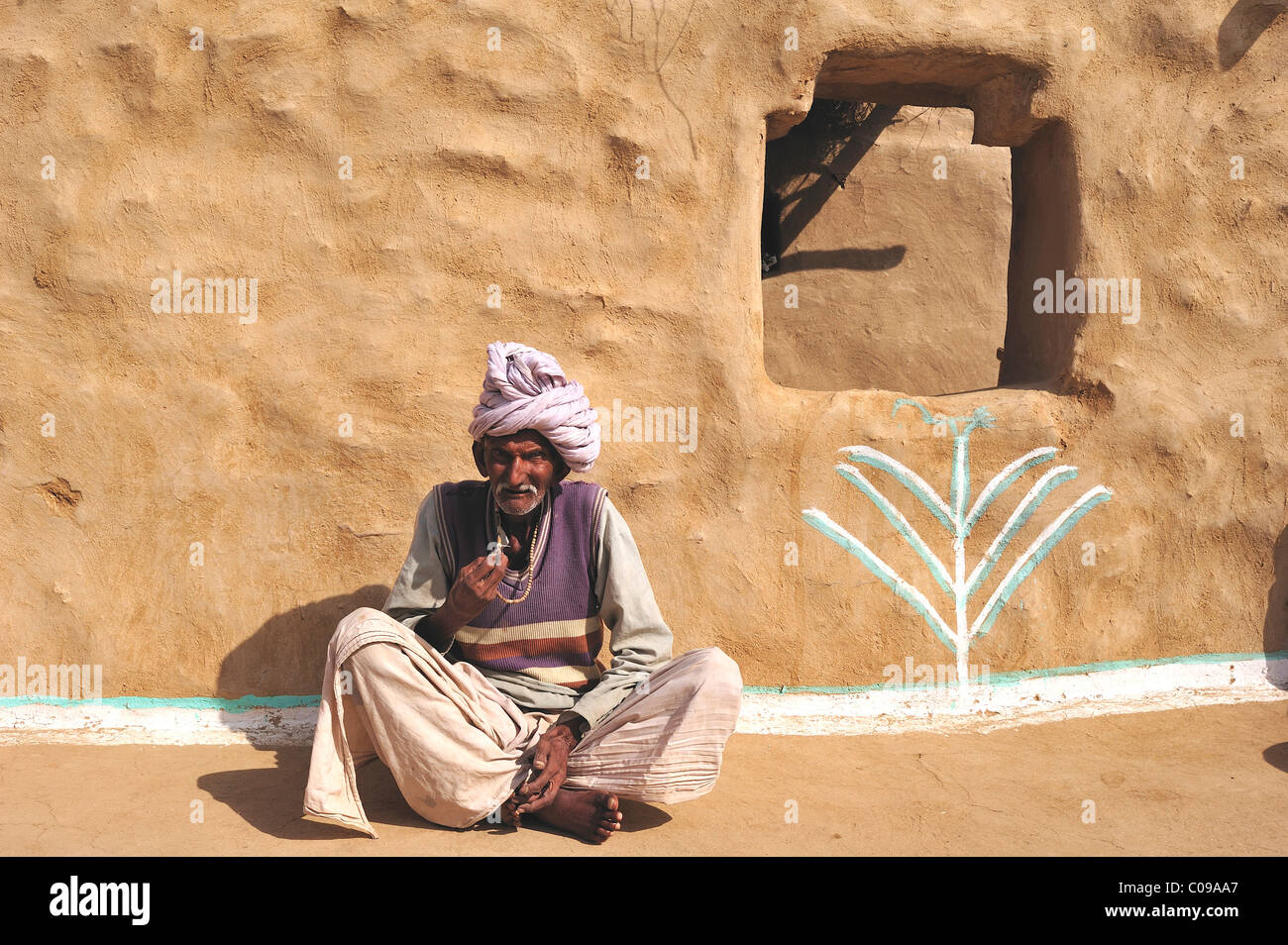 Old man with a turban in front of his house, Thar Desert, Rajasthan, India, Asia Stock Photo