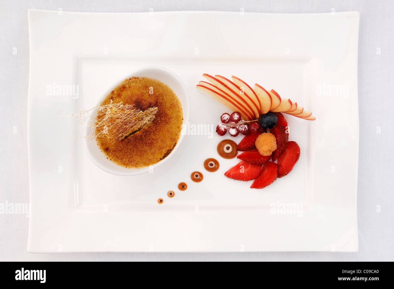 Dessert, tonka bean crème brûlée decorated with fruit, Haute Cuisine