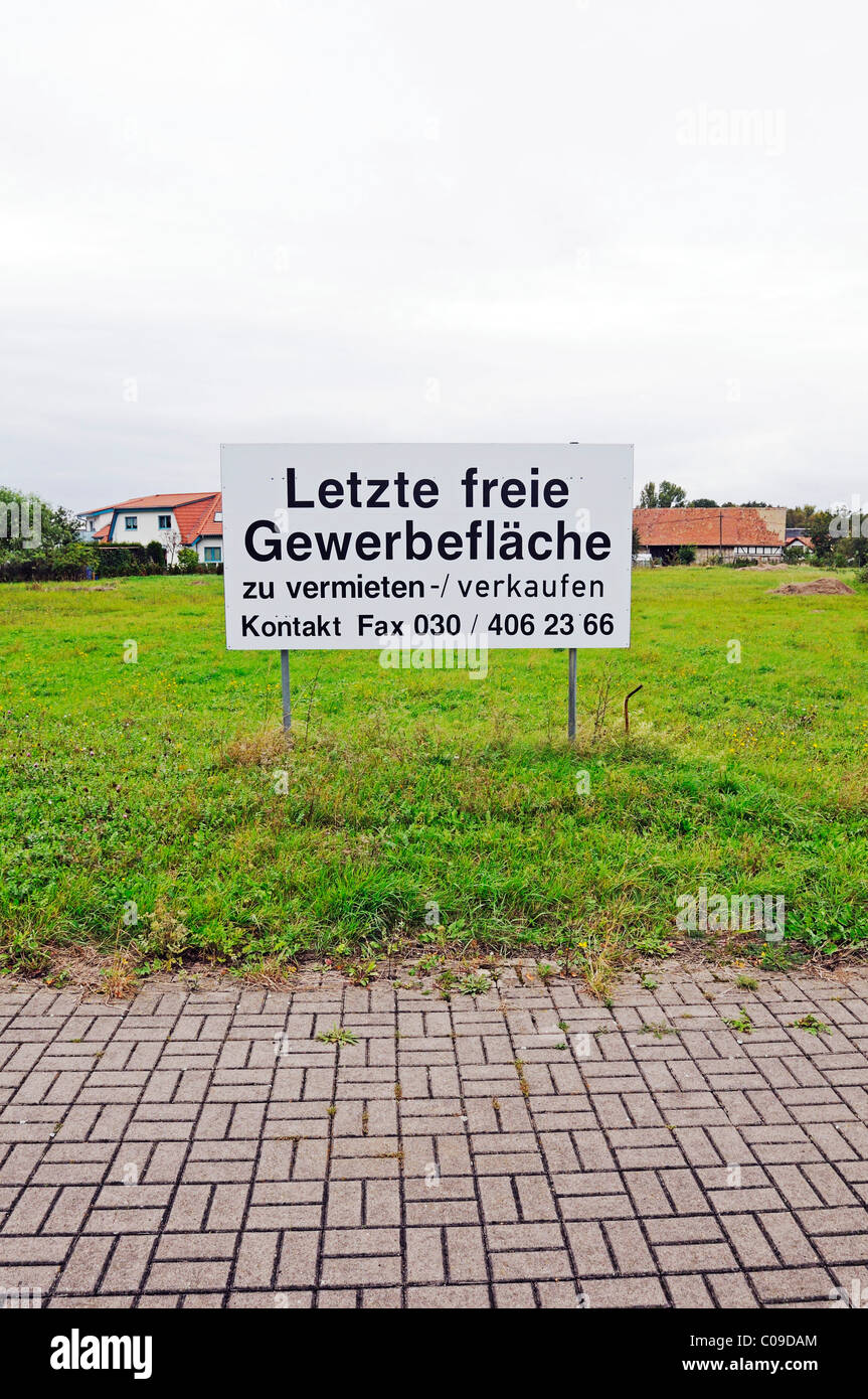 Sign 'Letzte freie Gewerbeflaeche', last free commercial space, in an industrial zone in the economically underdeveloped region Stock Photo