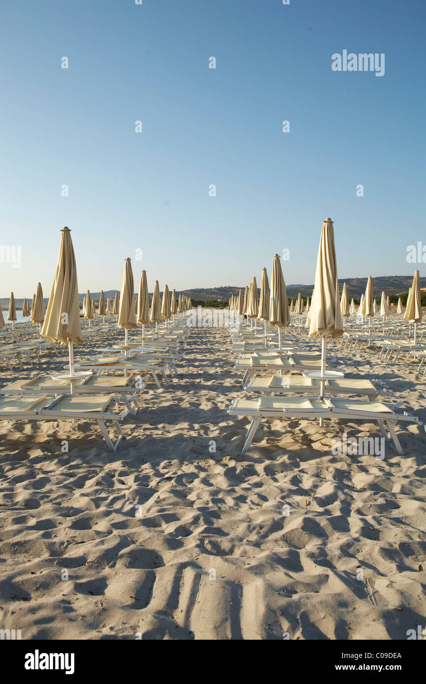 Parasols and sunloungers on the beach in the morning Stock Photo