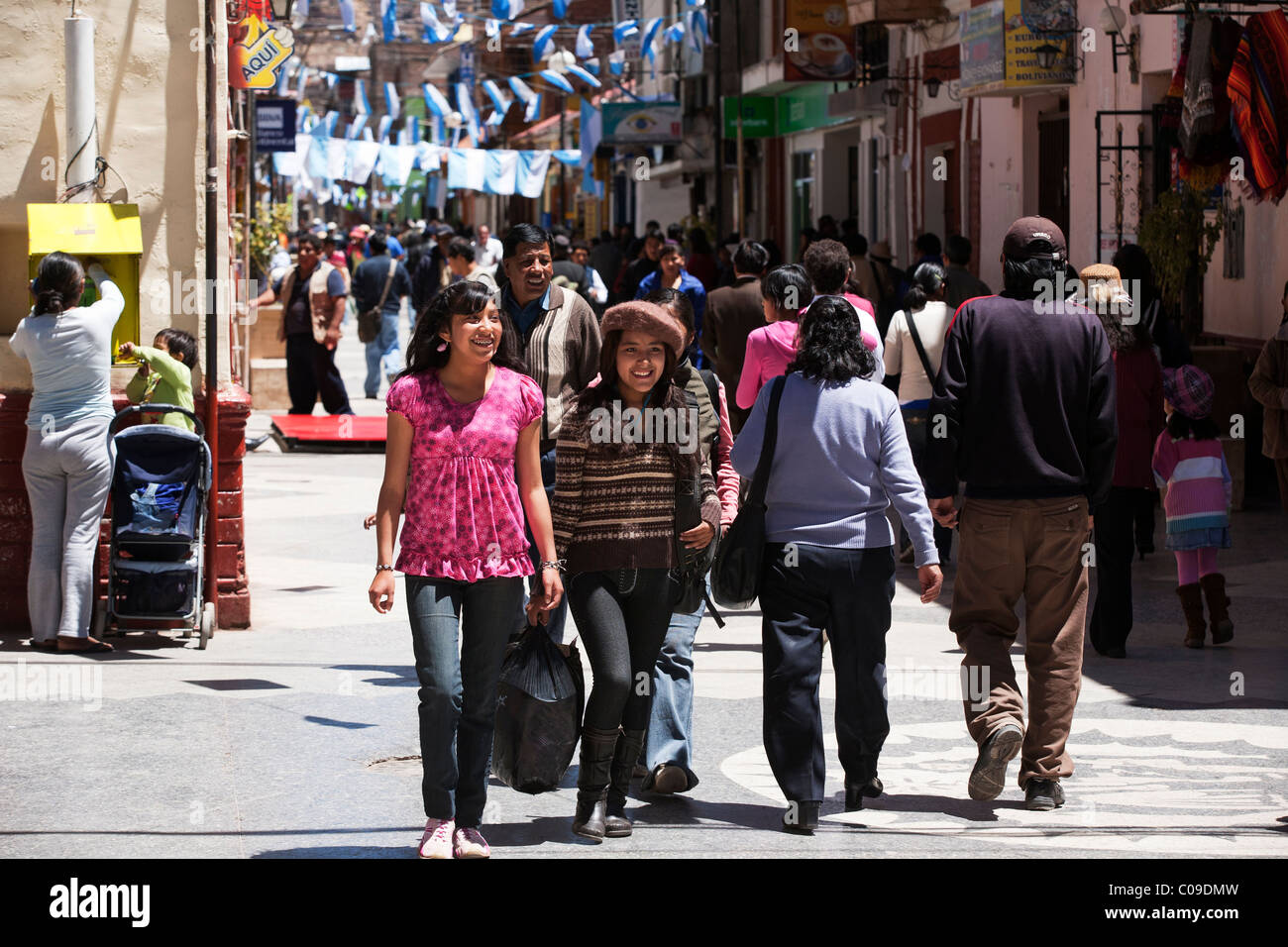 Two girls walk down the maion street of Puno, JR Lima. Stock Photo
