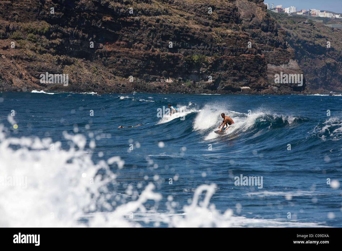 Bodyboarder bodyboarding waves by cliffs at Playa Nogales on the east coast La Palma Canary Islands Spain Stock Photo
