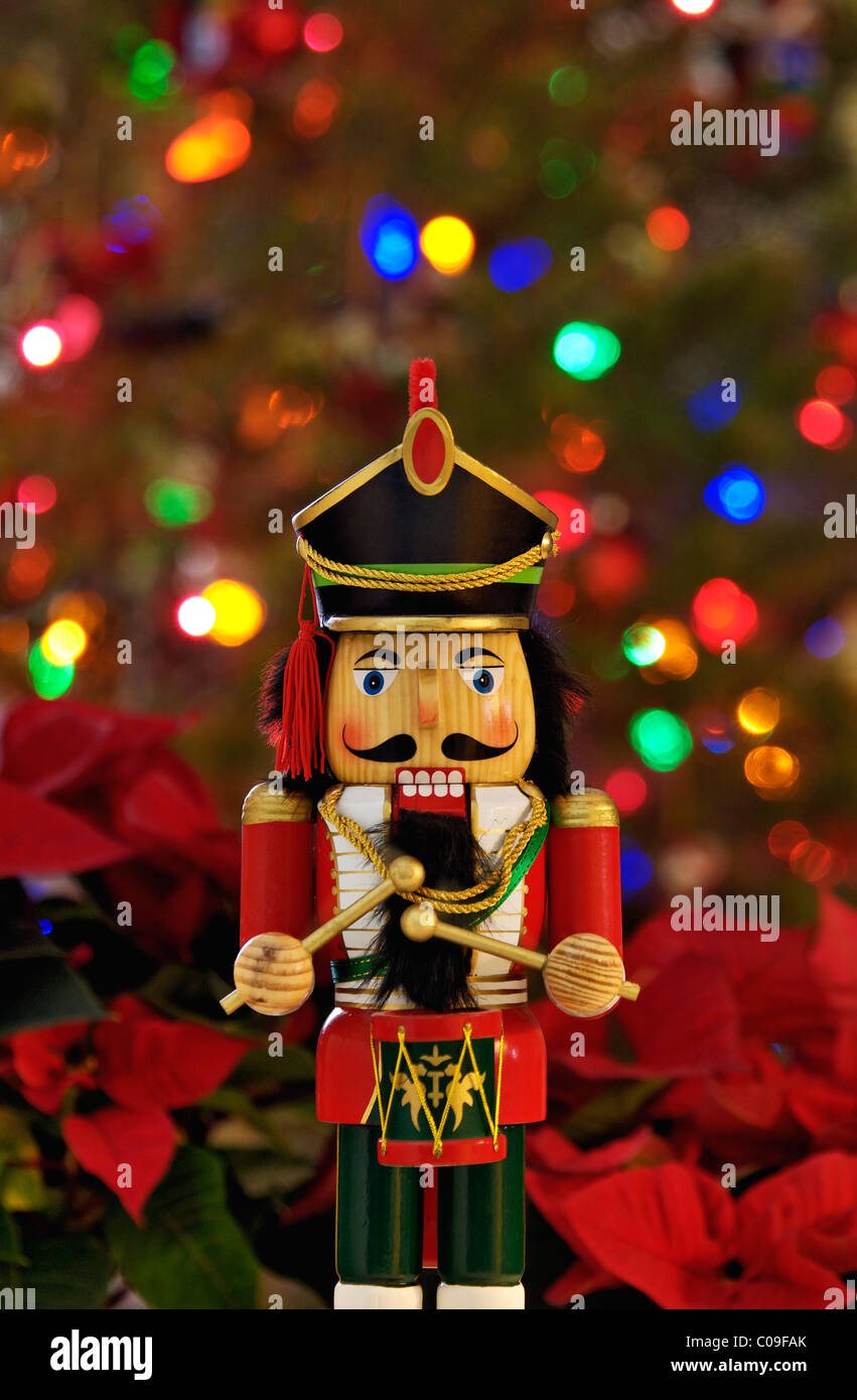 Nutcracker with Background of Poinsettia and Christmas Tree Stock Photo